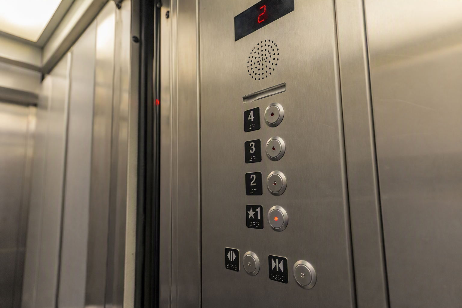 ADA Elevator Panel — Hotel Cab ADA-compliant hotel elevator control panel with Braille indicators, tactile buttons, and door reopening sensor in a Florida hospitality building elevator cab