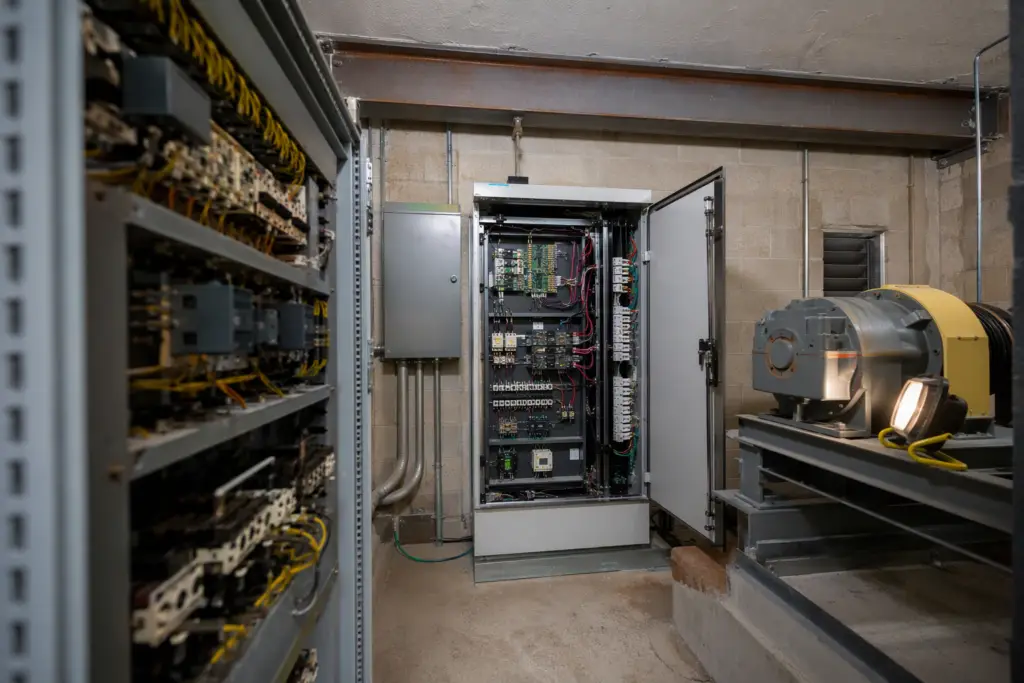 New solid-state elevator controller installed during a Florida apartment building elevator modernization, triggering ASME A17.3 code compliance upgrades in Pompano Beach FL