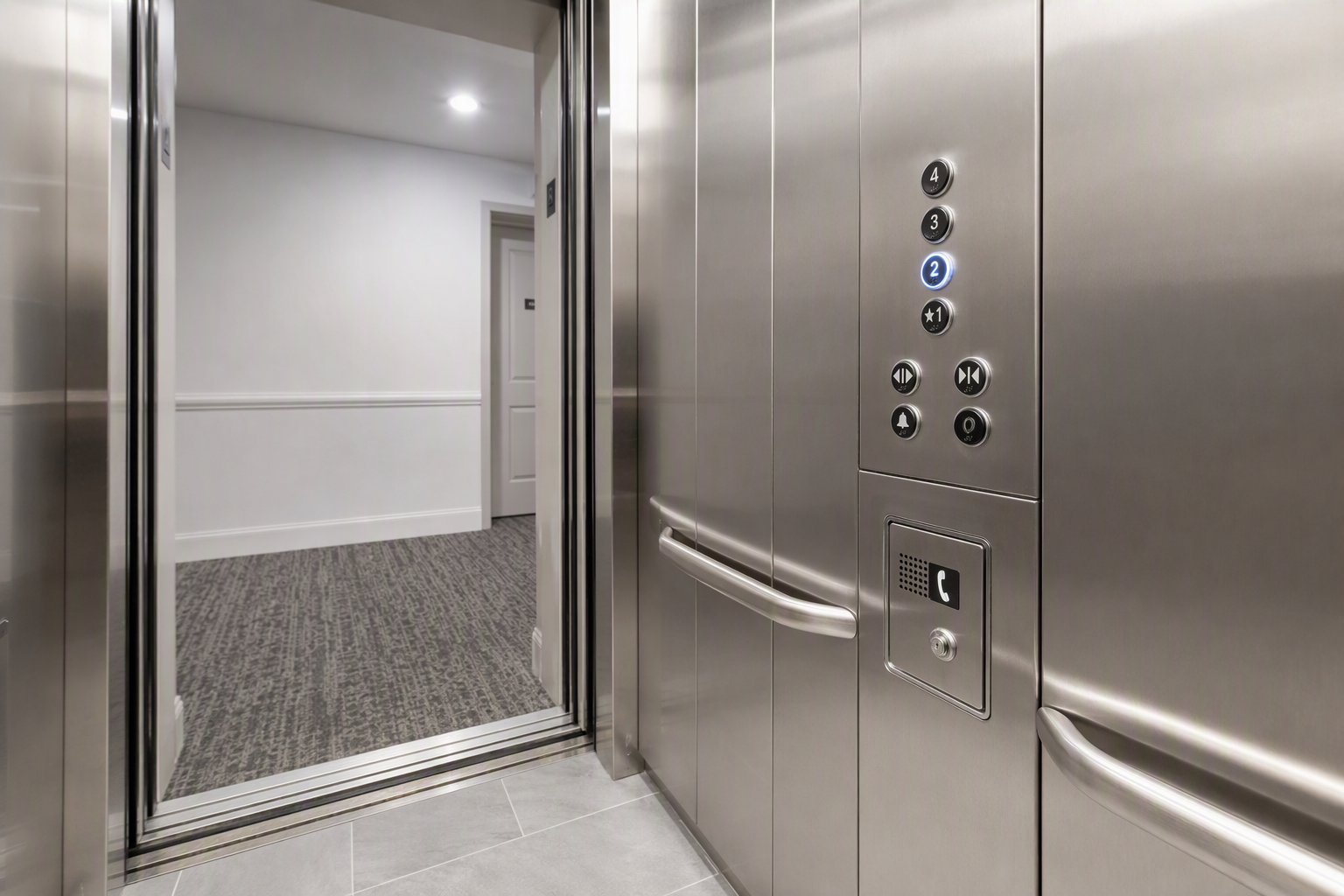 ADA-compliant elevator cab interior in a Florida apartment building showing Braille tactile buttons, handrail, and emergency phone panel required for multifamily safety compliance