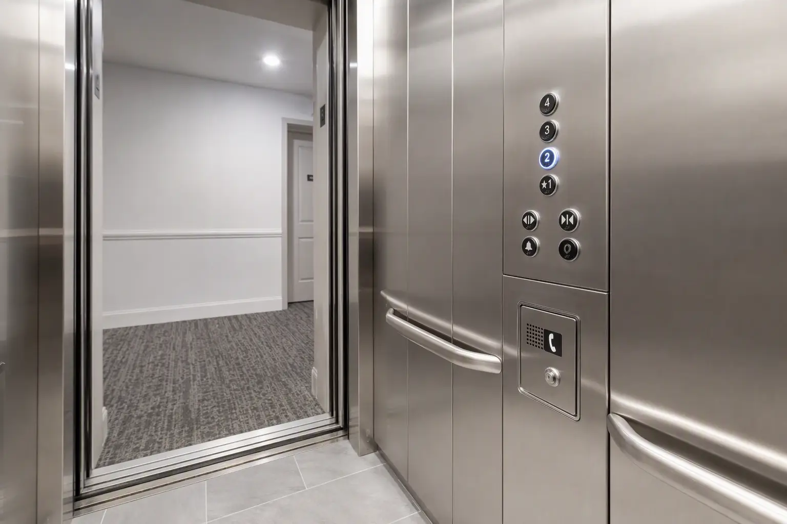 ADA-compliant elevator cab interior in a Florida apartment building showing Braille tactile buttons, handrail, and emergency phone panel required for multifamily safety compliance