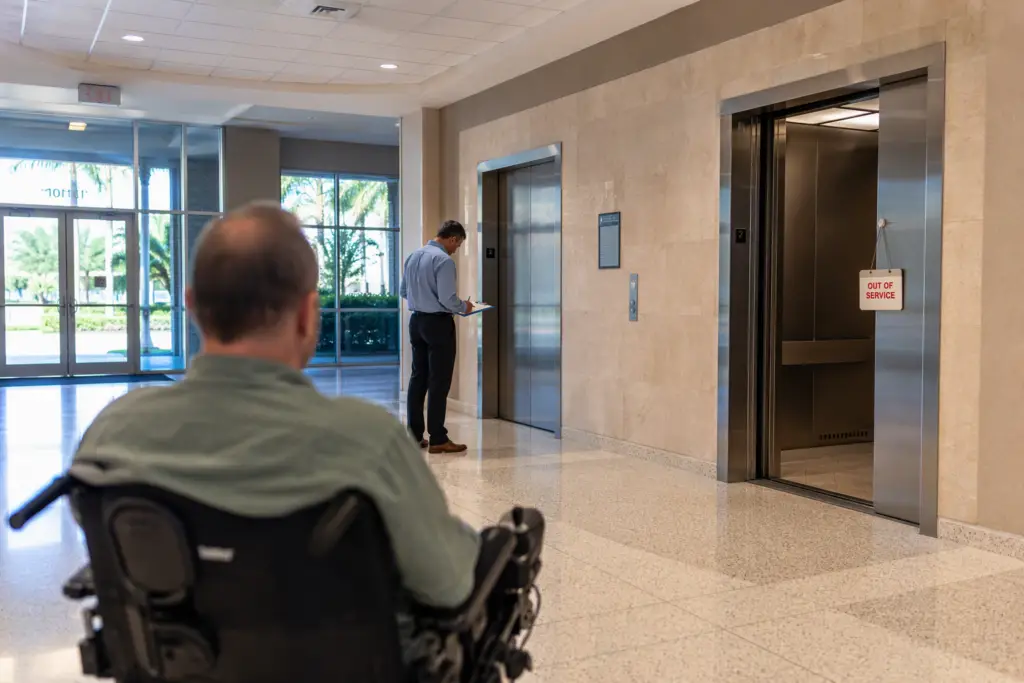 Out-of-service elevator in a multitenant medical office building lobby in Florida, illustrating how elevator downtime creates ADA liability and tenant retention risk